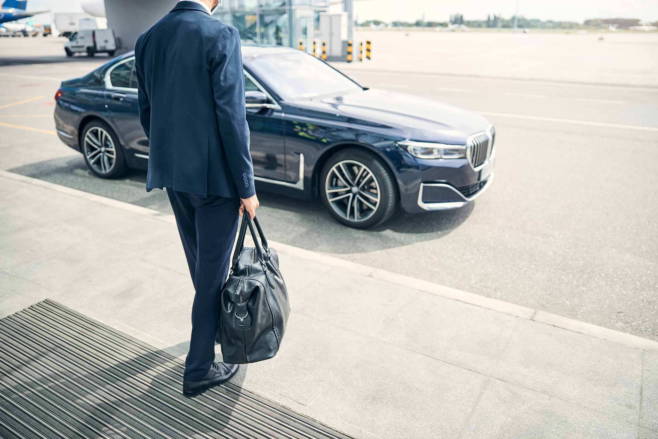 Businessman coming abroad and the car waiting for him